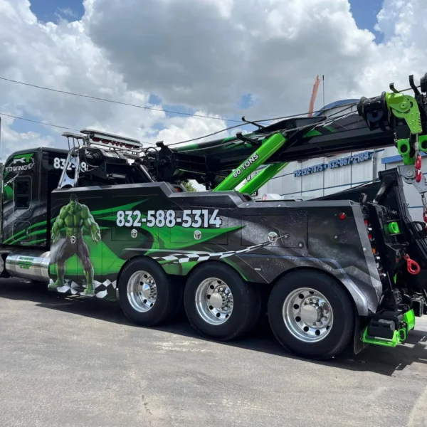 IND-60 heavy-duty independent wrecker parked roadside, showing multi-axle configuration and extended boom