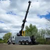 Metro IND-60 independent wrecker demonstrating full boom extension in open field