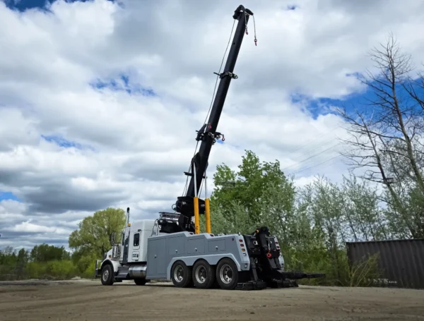 Metro IND-60 independent wrecker demonstrating full boom extension in open field
