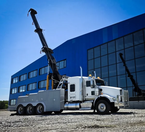 Metro Tow Trucks IND-60 independent wrecker with boom raised beside office building