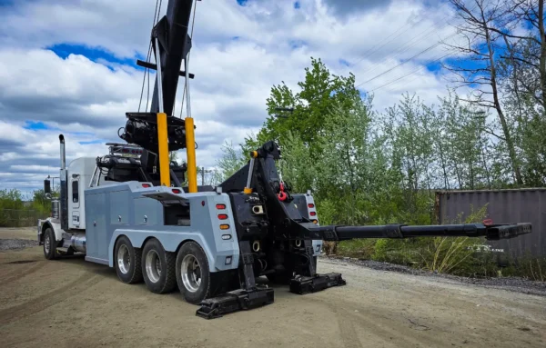 Metro Tow Trucks IND-60 independent wrecker with boom raised beside office building
