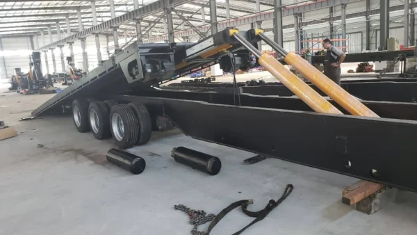 STT-50 extendable heavy-haul trailer inside workshop during assembly with axles, suspension and frame components