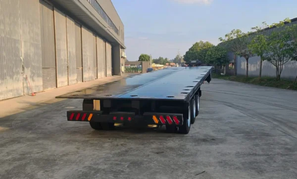 Rear view of STT-50 trailer showing tri-axle configuration, LED lighting and rear underride protection