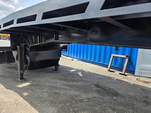 Close-up underside view of STT-50 trailer frame, showing landing gear, reinforced beams and cross-members