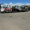 STT-50 trailer hooked to a highway tractor, transporting industrial equipment across a yard