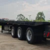 Side view of the STT-50 multi-axle heavy-haul trailer parked in a yard with full deck and suspension visible