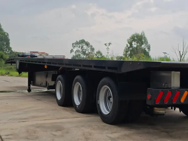Side view of the STT-50 multi-axle heavy-haul trailer parked in a yard with full deck and suspension visible