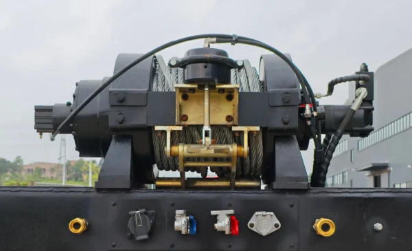 Top-mount winch assembly on the STT-50 trailer, showing cable drum, guides, and hydraulic connections