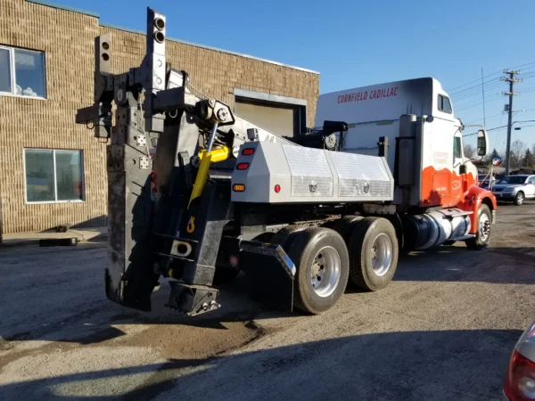 Close side view of MDTU-20 detachable heavy-duty underlift system with red boom and stabilizers