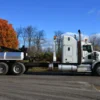 White MDTU-20 detachable tow truck side view in a rural area with fall foliage