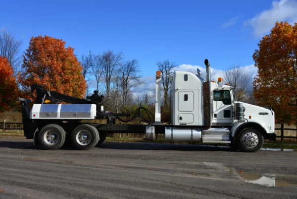 White MDTU-20 detachable tow truck side view in a rural area with fall foliage