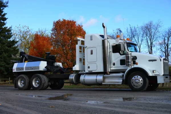 Side profile of white MDTU-20 detachable wrecker with autumn background