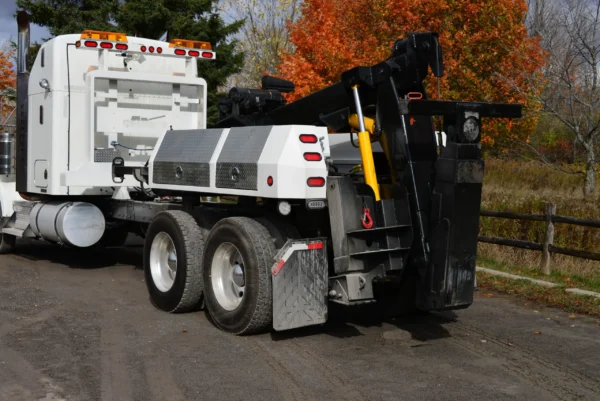 MDTU-20 detachable wrecker body mounted on white semi-truck with boom and underlift deployed