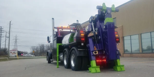 Rear view of MDTU-20 detachable tow body with stabilizers and underlift visible, outdoor industrial setting
