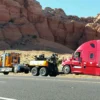 MDTU-35 detachable towing unit transporting a semi-truck on a highway near red rock scenery