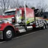 Custom-painted Metro RTR-25 rotator wrecker towing a bus on highway