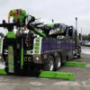 RTR-25 rotator tow truck deploying outriggers for stabilized lifting operations