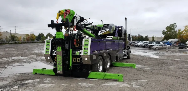 RTR-25 rotator tow truck deploying outriggers for stabilized lifting operations