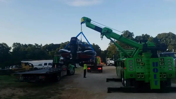 Metro Tow Trucks RTR-25 heavy duty rotator lifting a car with extended boom during vehicle recovery