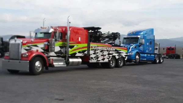 Metro Tow Trucks RTR-25 rotator towing a semi-truck on highway transport scene