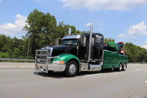 Metro Tow Trucks RTR-25 rotator heavy wrecker driving on road for recovery service