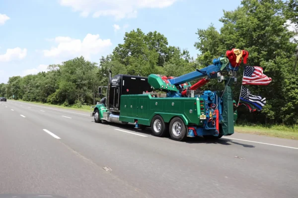 Metro Tow Trucks RTR-25 rotator driving on highway showing boom and underlift