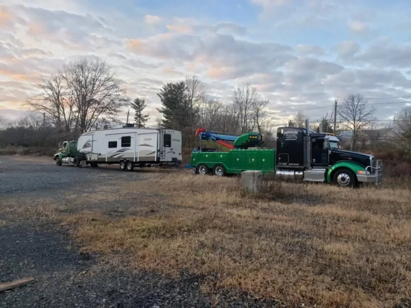 Metro Tow Trucks RTR-25 rotator towing a disabled RV in a rural roadside recovery